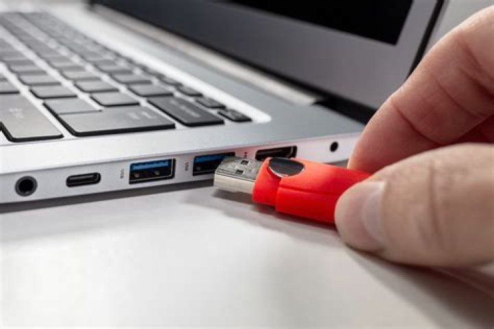 How do I enable USB charging on my laptop?