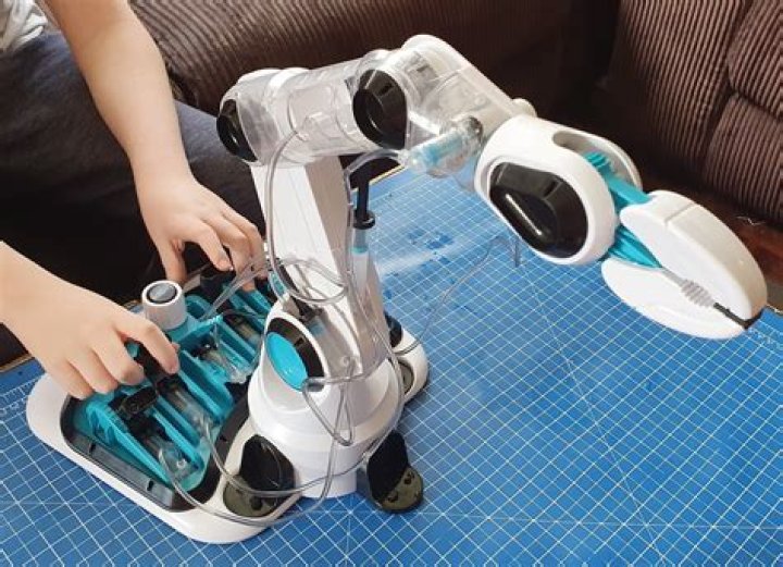 Who invented hydraulic robotic arm?